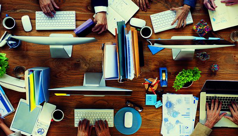 Group of Business People Working on an Office Desk